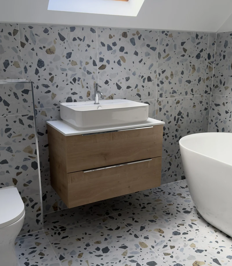 Oak vanity unit with countertop basin beside the freestanding bath, Letchworth Garden City
