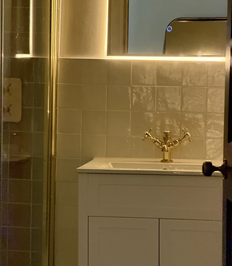 Backlit mirror above the shaker vanity, bathroom installation