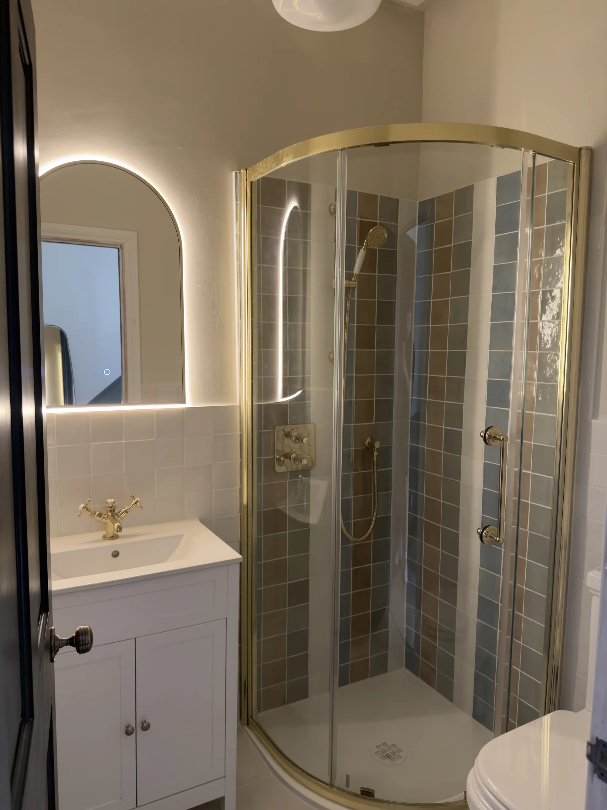 Brass-framed quadrant shower enclosure, bathroom installation