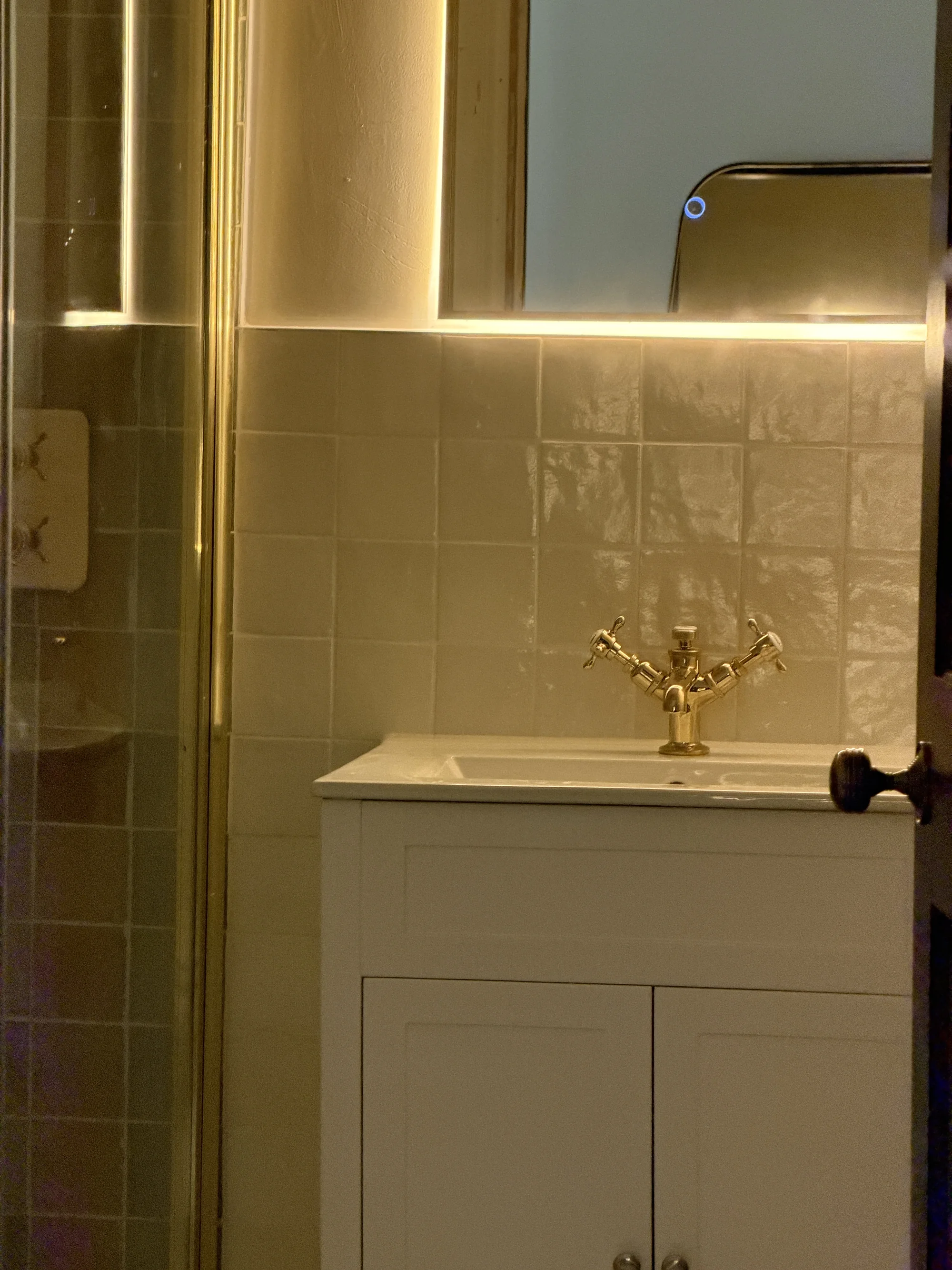 Warm-lit vanity and backlit mirror, bathroom installation