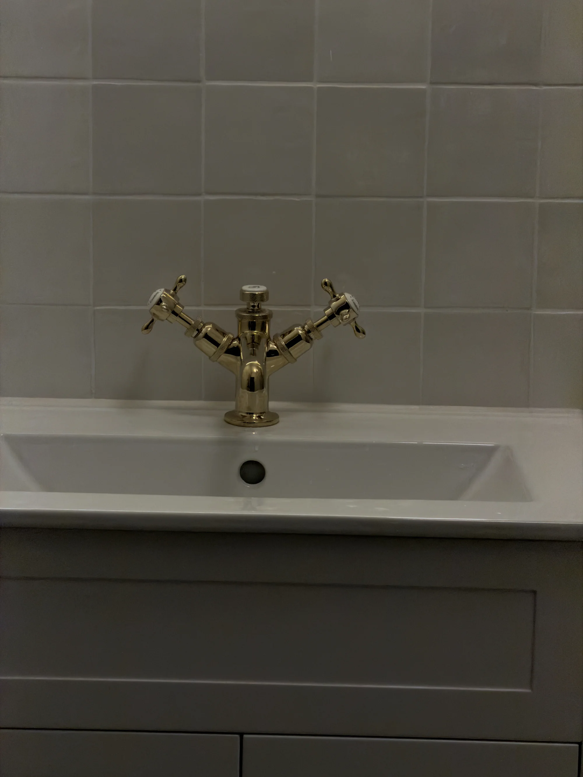 Brass crosshead tap detail on the countertop basin