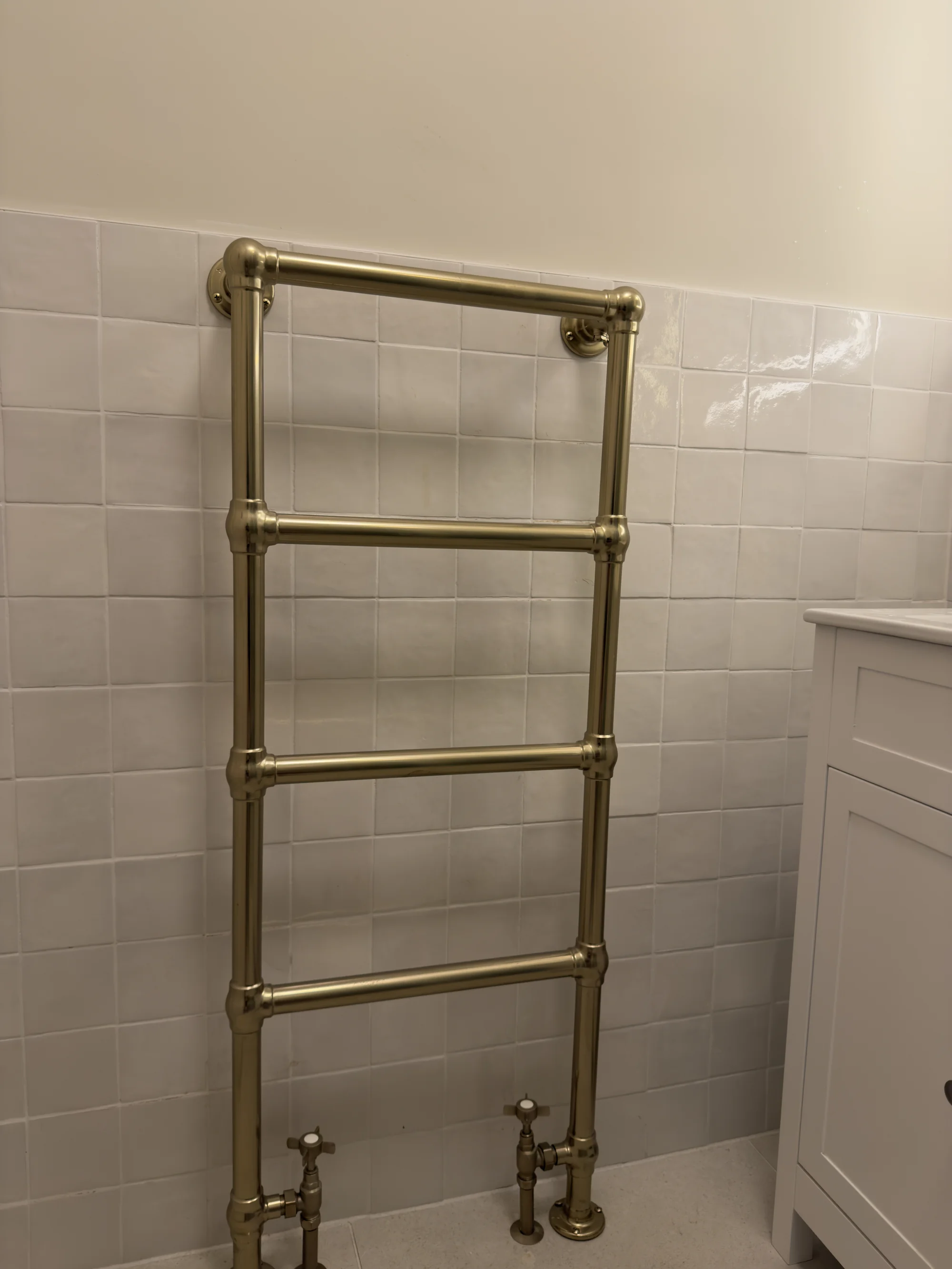 Traditional brass heated towel rail, bathroom installation