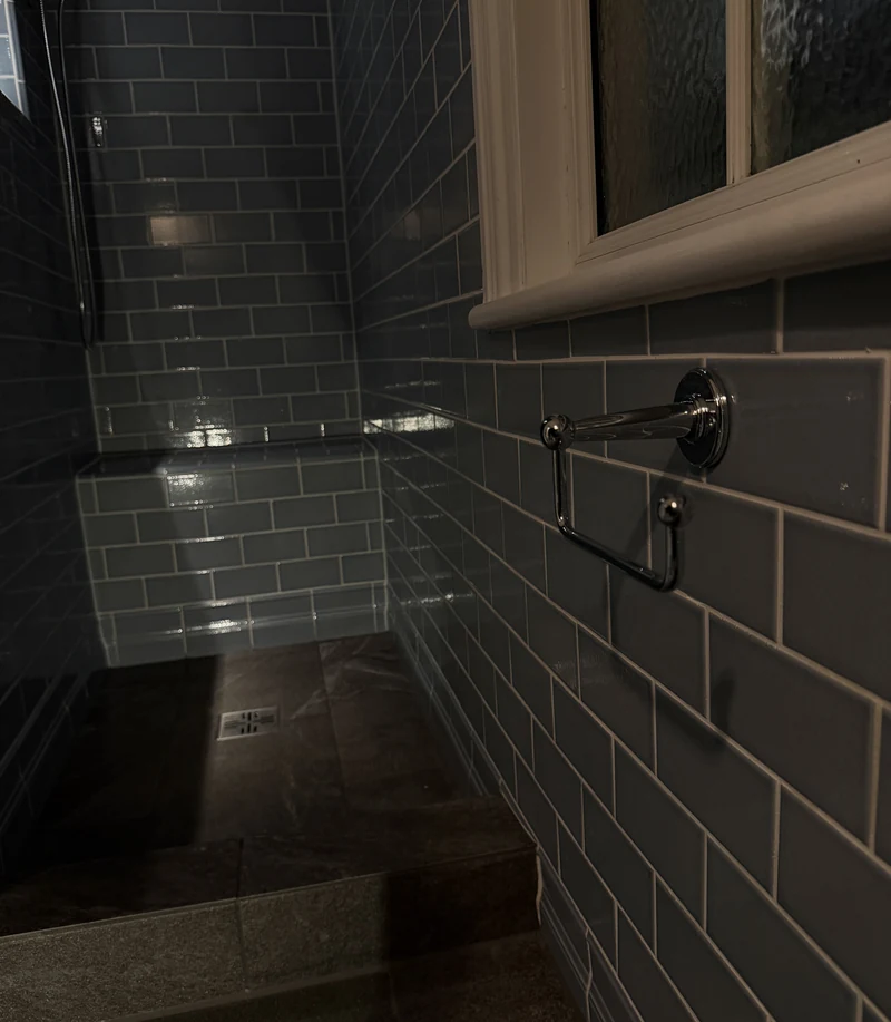 Walk-in shower with stone floor beside the window, St Albans