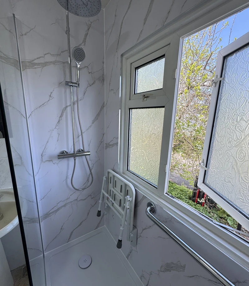 Thermostatic shower controls set at reachable height, Hertfordshire