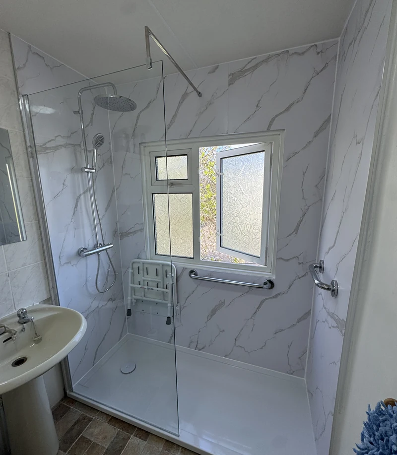 Pedestal basin beside the level-access shower, accessible bathroom Hertfordshire