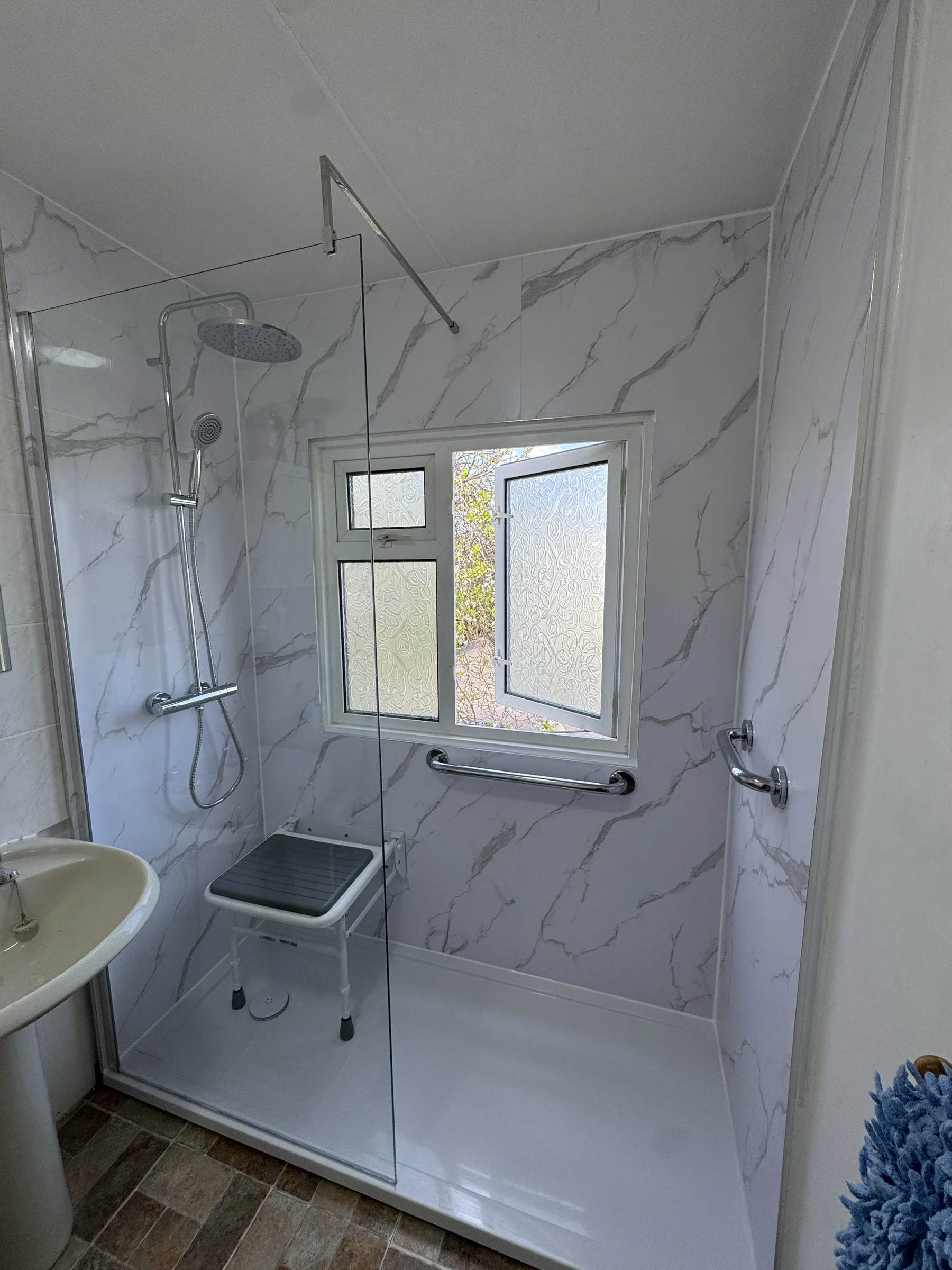 Level-access shower, fold-down seat and pedestal basin, accessible bathroom Hertfordshire