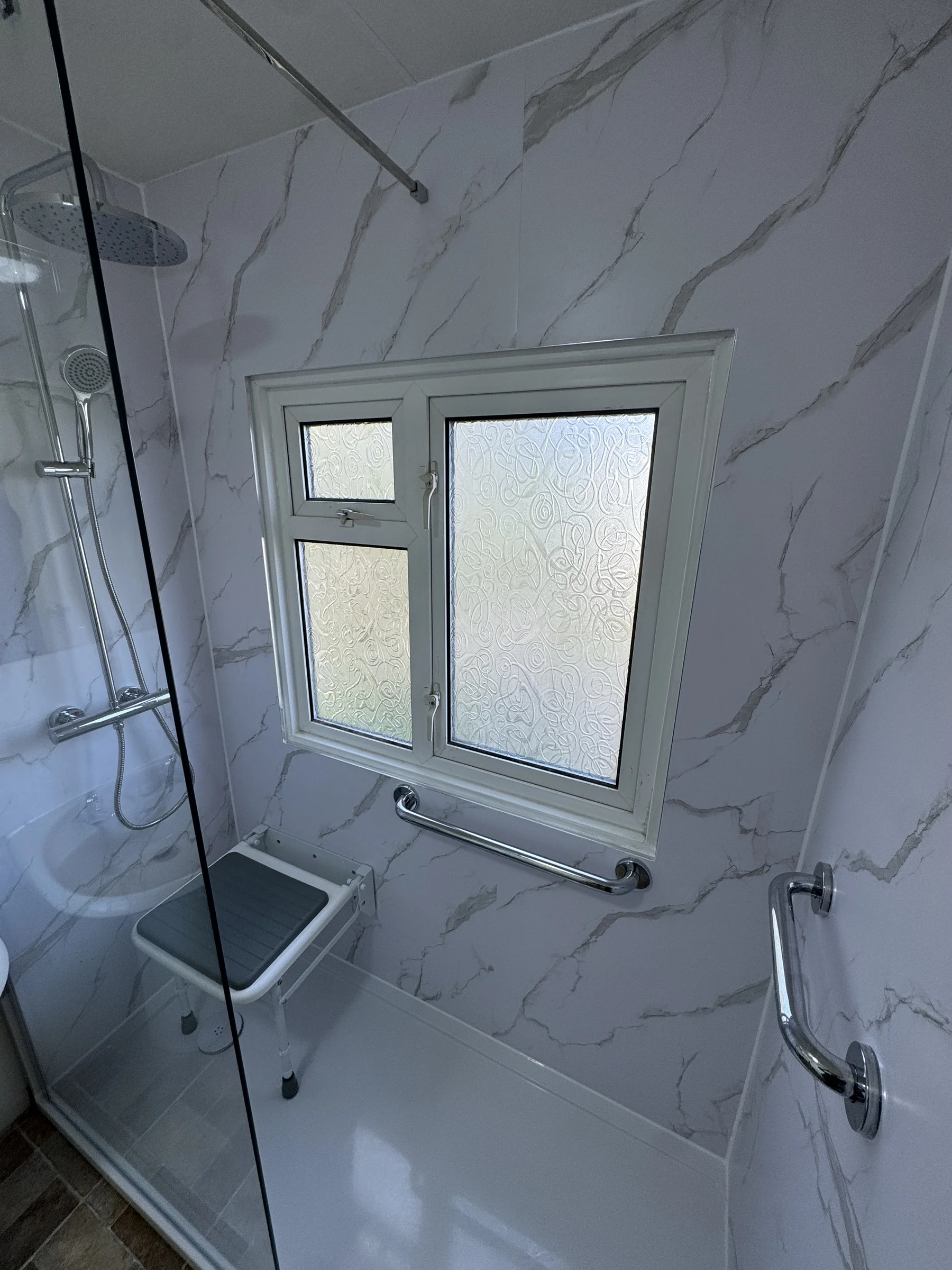 Walk-in shower with grab rails and fold-down seat, Hertfordshire