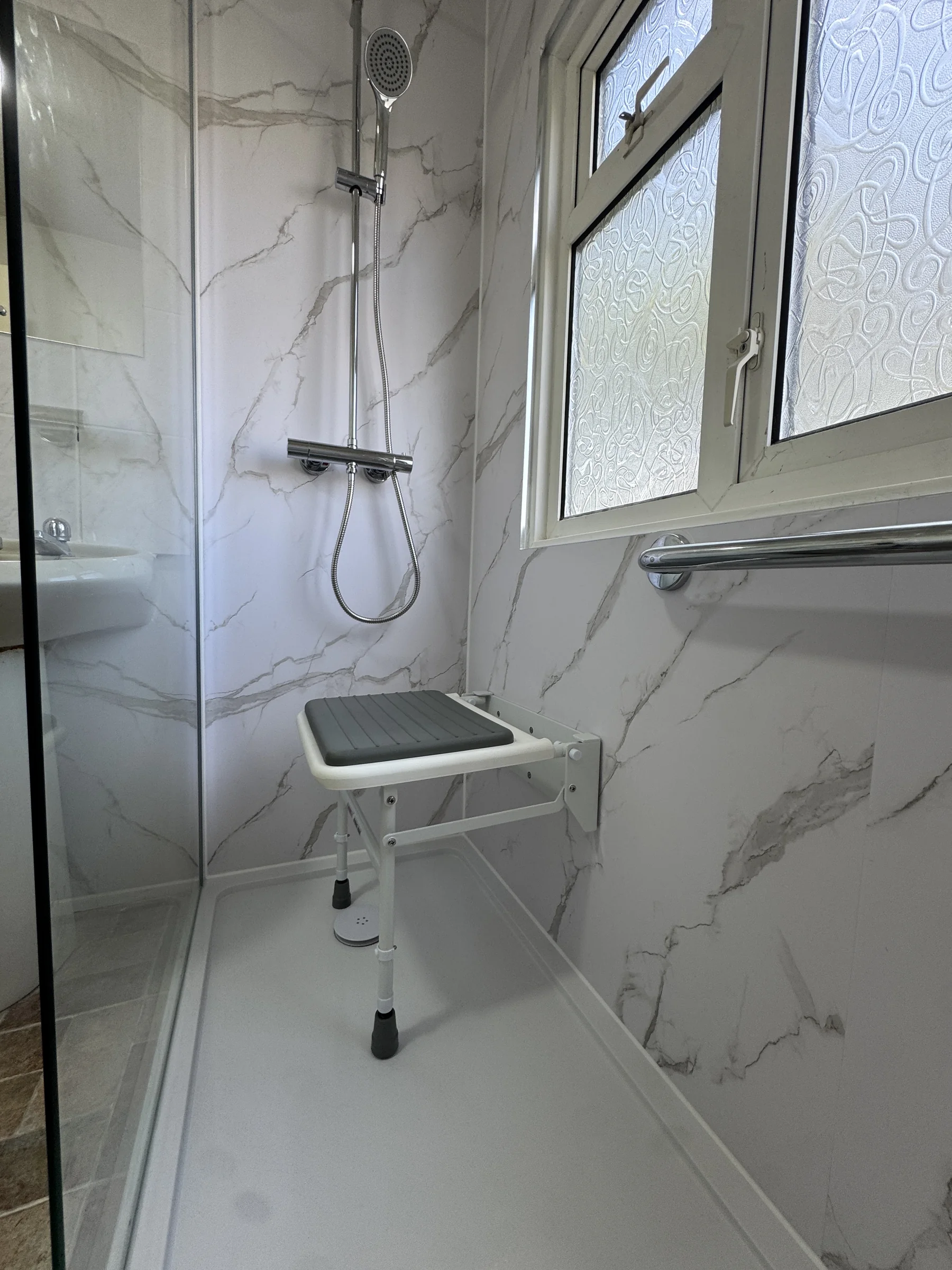 Fold-down seat and shelf in the walk-in shower, Hertfordshire